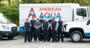 Eight American Aqua team members standing in front of an American Aqua truck